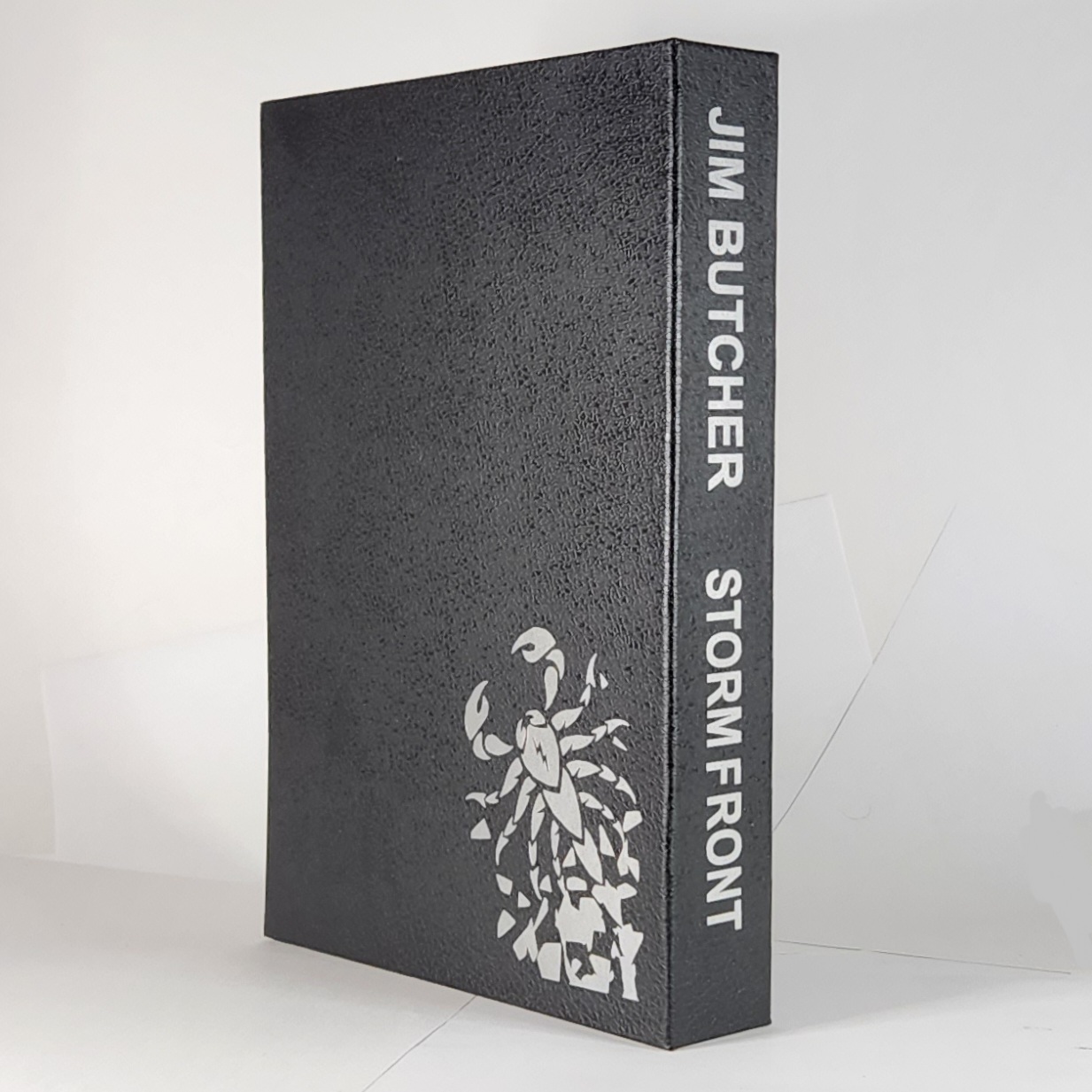 Custom Book Slipcase Design for the Storm Front by Jim Butcher with silver icon and author and title text.
